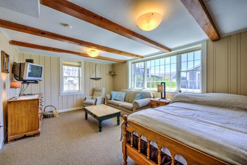 a bedroom with a bed and a couch and a tv at 197 North Shore Boulevard East Sandwich - Cape Cod in East Sandwich