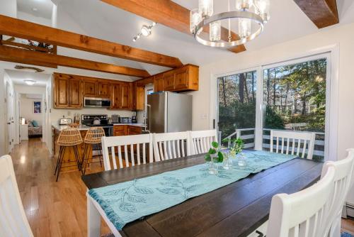 a dining room and kitchen with a table and chairs at 1325 Bridge Road Eastham Cape Cod - - Turtle Dreams in Eastham