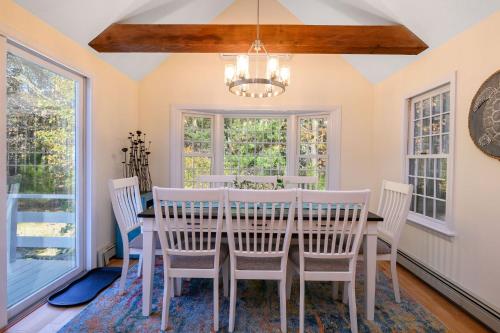 a dining room with a table and chairs and a chandelier at 1325 Bridge Road Eastham Cape Cod - - Turtle Dreams in Eastham