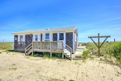 a small house with a porch on the beach at Sagamore Beachfront Cottage Escape in Sagamore Beach
