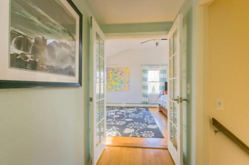 a hallway of a home with a painting on the wall at 17 Woodland Avenue Mashpee Cape Cod - - The Cape Escape in Mashpee
