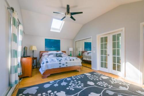 - une chambre avec un lit et un ventilateur de plafond dans l'établissement 17 Woodland Avenue Mashpee Cape Cod - - The Cape Escape, à Mashpee