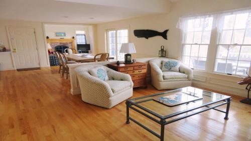 a living room with two chairs and a table at 151 Sky Way Chatham Cape Cod- -Cape Time in Chatham