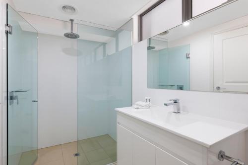 a bathroom with a sink and a glass shower at Quest Portland in Portland