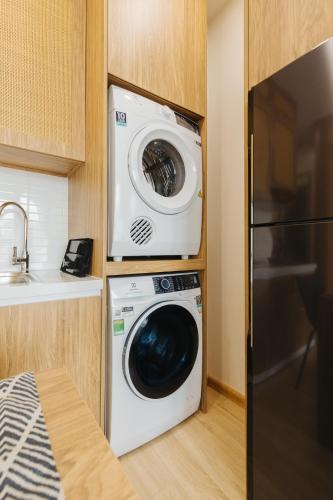 a washer and dryer in a small kitchen at Myrcella Urban Studio in Hanoi
