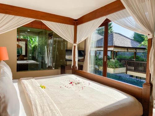 a bedroom with a bed with flowers on it at Alea Villa by Premier Hospitality Asia in Jimbaran