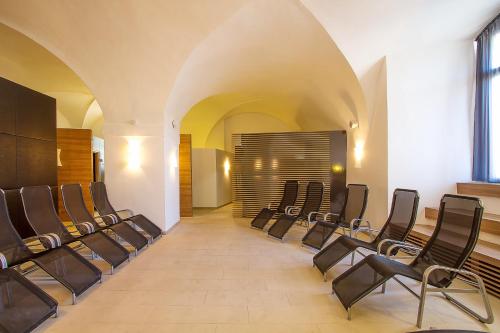 a row of chairs in a room with an aisle at Hotel Altes Kloster in Hainburg an der Donau