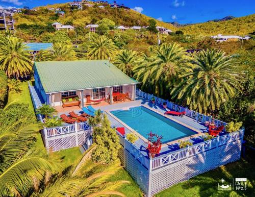 an aerial view of a house with a swimming pool at Villa Lazy Daze in Jolly Harbour