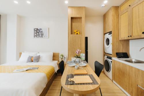 a bedroom with a bed and a table in a room at Myrcella Urban Studio in Hanoi