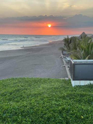 a view of the beach with the sun setting at La casa del Argentino in Hawaii