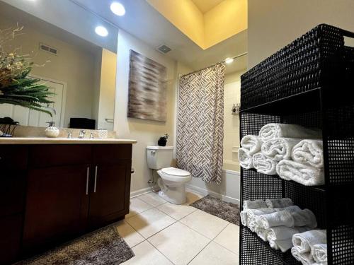 a bathroom with a toilet and a sink with towels at Atlanta Luxurious Apartment in Atlanta