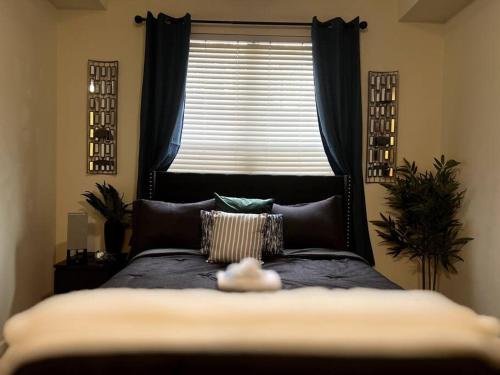 a bedroom with a large bed with a window at Atlanta Luxurious Apartment in Atlanta