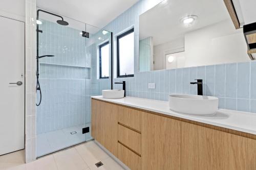 a bathroom with two sinks and a shower at 1 Horizon Terraces Beautifully Styled Duplex Perfect Beach Vibes in Sunshine Beach
