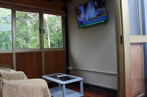a living room with a tv on the wall at CORAGGIOSA in Mendoza