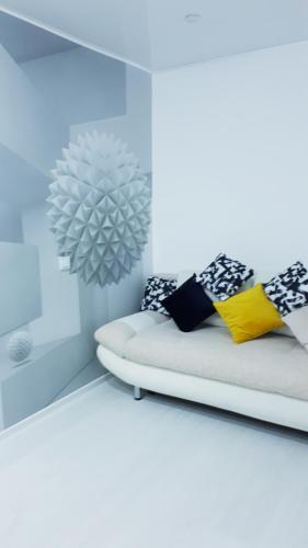 a white room with a bed and a mirror at Апартаменты с шикарным видом на море in Aktau
