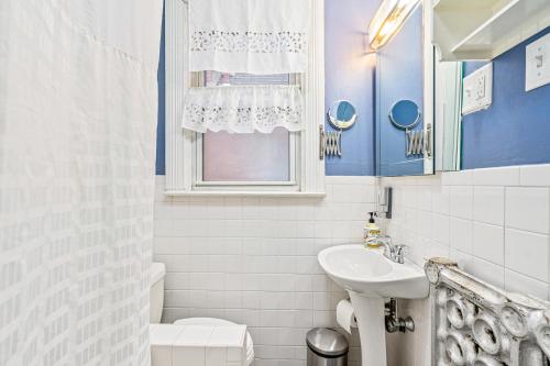 a blue and white bathroom with a sink and a toilet at Big house private room in Pittsburgh