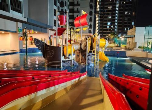 a water park with a slide and some red benches at NEW Stylish Seaview Bali Residences studio near Jonker 4 pax in Melaka
