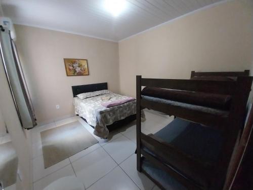 a small bedroom with a bed and a staircase at Presidente Cepop 2 in Campos dos Goytacazes