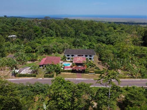 an aerial view of a house with a truck at Natura Gardens Galápagos in Bellavista