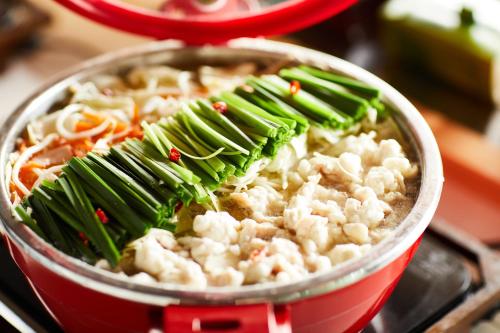a pot of food with vegetables on top of it at The358 UMI in Fukuoka