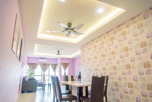a dining room with a table and a ceiling fan at Sekinchan Paddy via Seaview Home in Sekincan