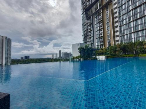 a large swimming pool in a city with tall buildings at Medini Elysia Park , 3 min to Legoland, Netflix By Hint Homestay in Nusajaya