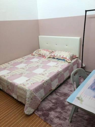 a small bedroom with a bed and a table at irdahusna homestay in Rasa