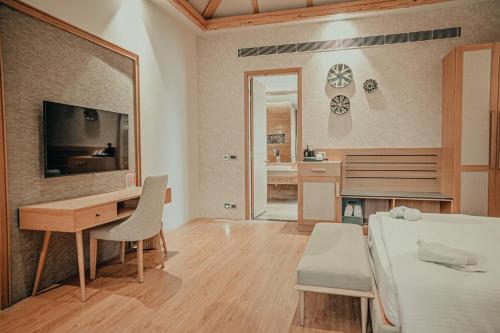 a bedroom with a desk and a bed and a desk and chair at Pushkara Resort and Spa, Pushkar in Pushkar