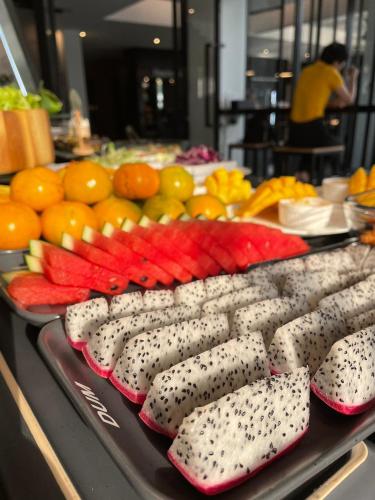 a buffet of cookies and fruit on a table at DUM Hotel - Si Phum in Chiang Mai