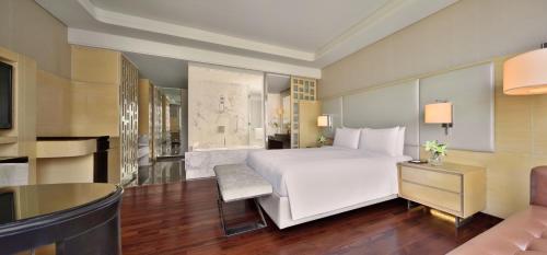 a bedroom with a large white bed and a couch at JW Marriott Hotel Chandigarh in Chandīgarh