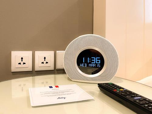a clock sitting on a table next to a keyboard at Ashley Sabang Jakarta in Jakarta