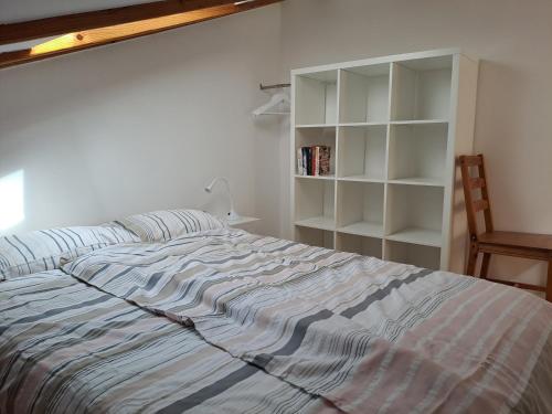 a bedroom with a bed and a book shelf at Apartments Gina in Piran