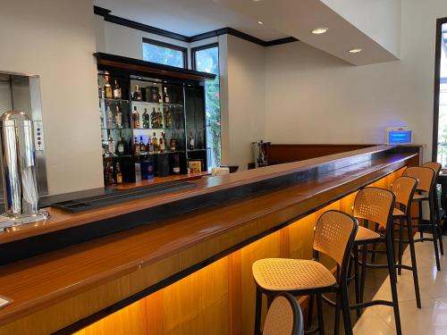 a bar with a row of chairs around it at Plaza Del Norte Hotel and Convention Center in Laoag