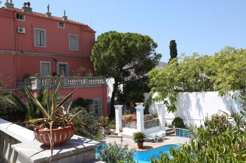 a house with a swimming pool next to a building at Villa Melina Hotel in Kalymnos