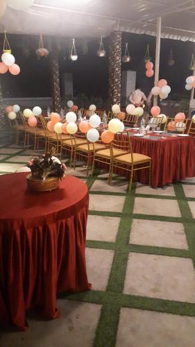 a group of tables and chairs in a room at Hotel Mirana , Tinsukia in Tinsukia