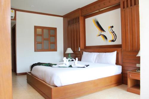 a bedroom with a bed with two swans on it at Talya Patong Hotel in Patong Beach