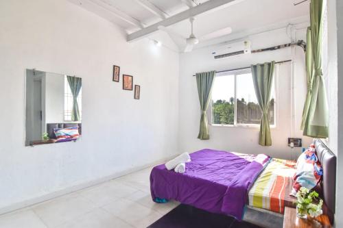 a bedroom with a bed and a window at Dev1villa in Lonavala