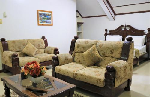 a living room with a couch and a table at PALM TREE RESORT AND RESTAURANT in Olongapo