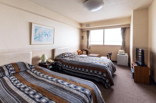 Posteľ alebo postele v izbe v ubytovaní Yunohama Hotel