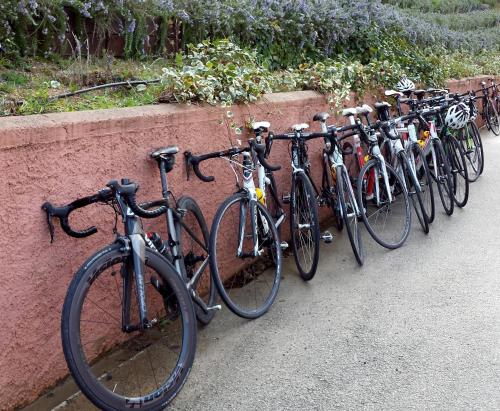 a row of bikes parked next to a wall at Pausania Inn in Tempio Pausania