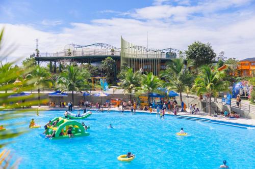 a group of people in a pool at a water park at Tea Resort in Bao Loc