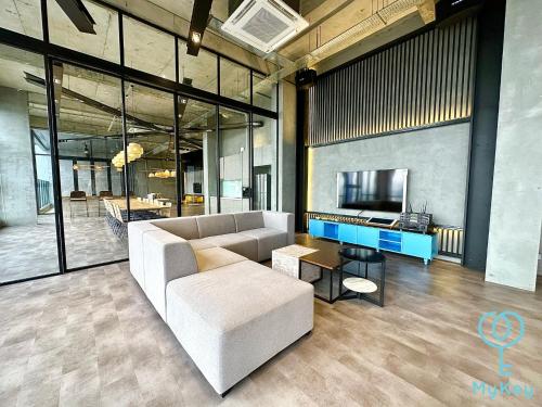 a living room with a couch and a tv at Millerz Square by Mykey Global in Kuala Lumpur