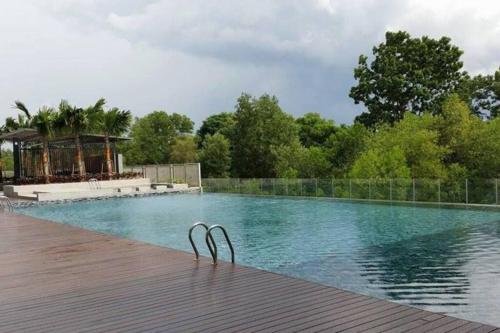 a large swimming pool with a wooden boardwalk at Skyloft Premium Suites 8 pax in Johor Bahru