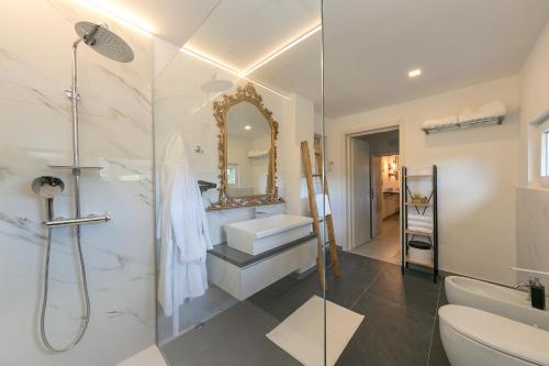 a bathroom with a shower and a sink and a toilet at Villa Cristina in Riparbella