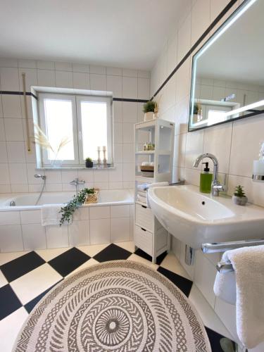 a white bathroom with a sink and a tub and a sinkessment at RONI APARTMENTS -111qm Luxury Loft -Near Center and Clinics -Netflix -Terrace -Close to Thermal Spa in Bad Aibling