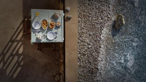 an overhead view of a table with plates of food at Akroyiali - Guesthouse in Gerolimenas