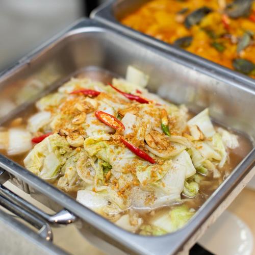 a tray of food with cabbage and other foods at โรงแรมมณีสังขะ in Sangkha