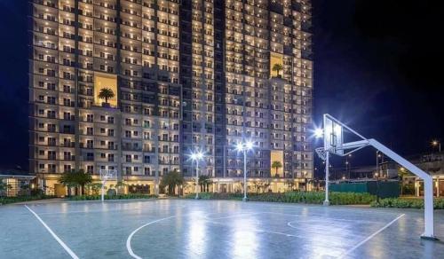 a basketball court in front of a building at night at Modern Living by The Celandine DMCI in Balintawak in Manila