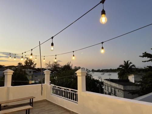 a patio with lights and a bench on a balcony at Studio H GrandBay Sea-View in Grand-Baie