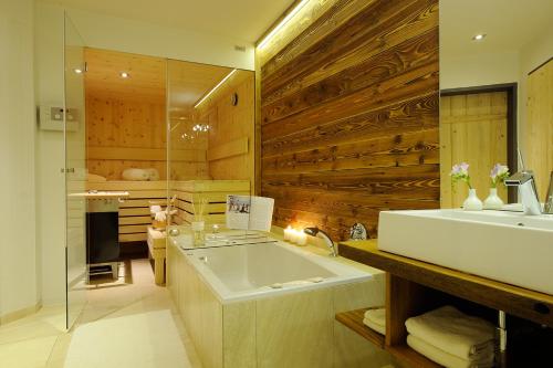 a bathroom with a large tub and a sink at Luxuslodge - Zeit zum Leben in Annaberg im Lammertal